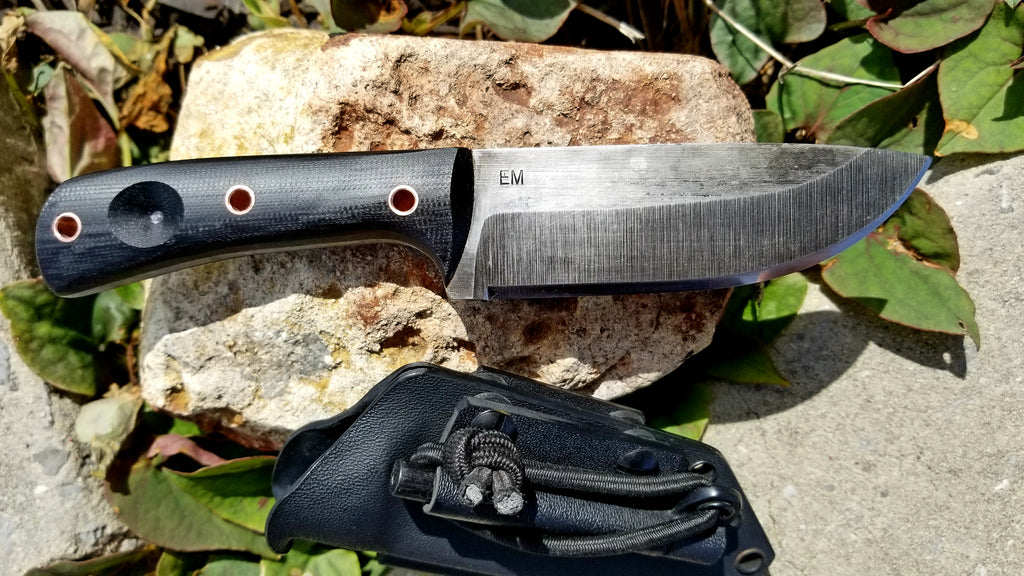 The Bushcrafter is your help in the woods while camping or for survival. Use it to cut small branches, clean fish, build shelter, clean game, or for defense. A bow drill divot helps to start fires, and it also comes with a vertical carry belt clip. Each blade is made of 1095 high carbon steel and is acid etched to inhibit rust. Since each knife is handcrafted, variations in the look of the blade and handle material are to be expected. 